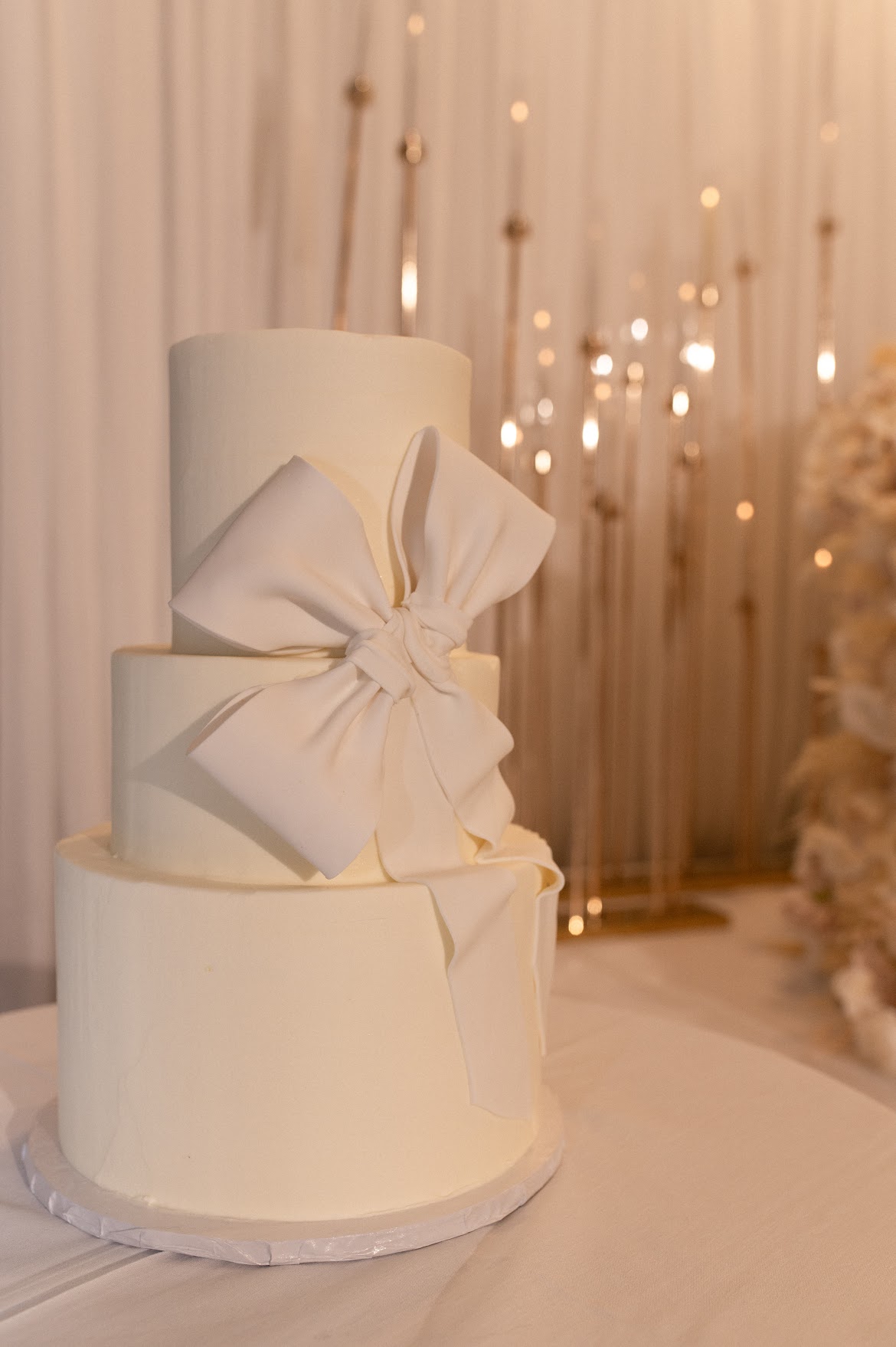 Three tier buttercream wedding cake in Edmonton with large fondant bow
